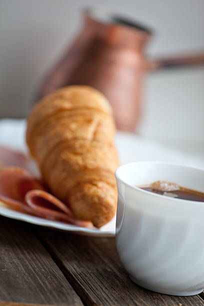 istock Continental breakfast with croissant and coffee, soft focus 481248100