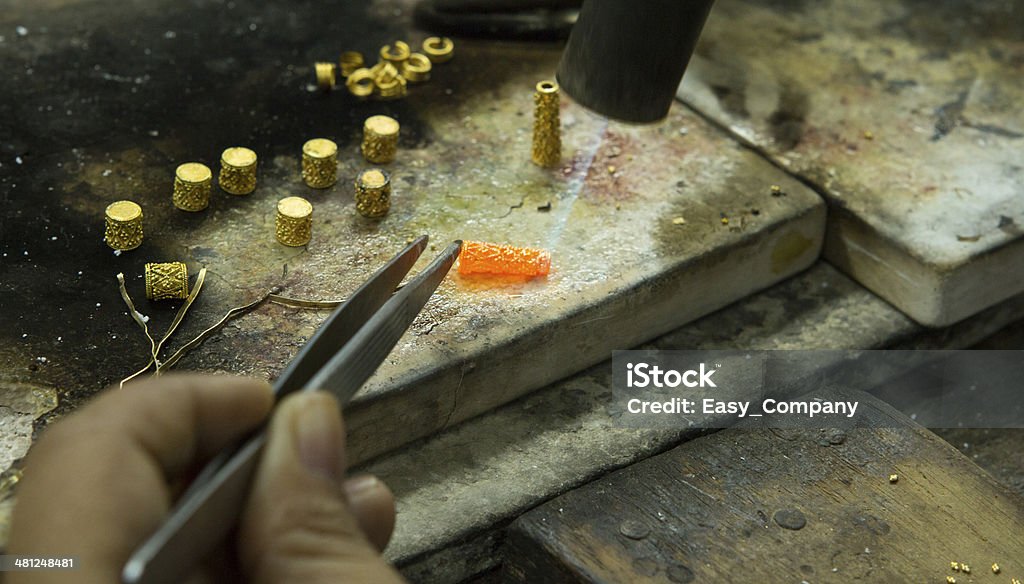 Goldsmith working with a unfinished work. Adult Stock Photo