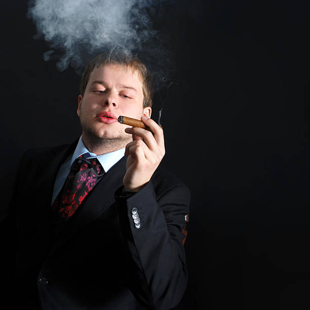 istock The man smoke a cigar with lots of smoke. A 481249248