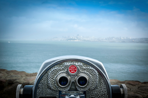 Binocular next to the waterside promenade at Golden Gate bridge San Francisco looking out to the Bay.