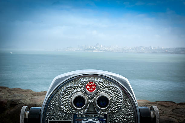 Coin operated binoculars Binocular next to the waterside promenade at Golden Gate bridge San Francisco looking out to the Bay. telescope lens stock pictures, royalty-free photos & images