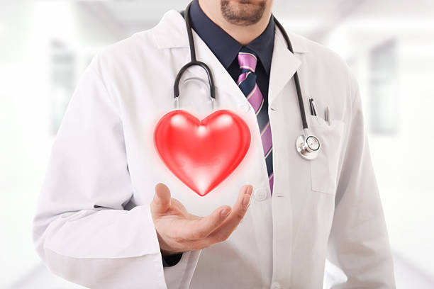 istock Male doctor showing a red heart 481257377