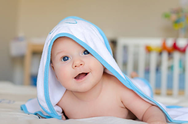 istock Smiling baby in a hooded towel after bath 481258417