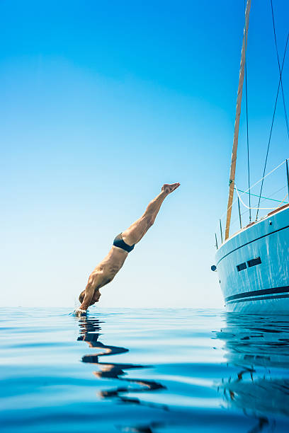 istock Man jumping in sea from sailboat 481259395