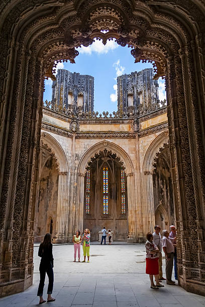 Tourists stroll around the interior of the Unfinished Chapels Batalha, Portugal - July 17, 2013: Tourists stroll around the interior of the Unfinished Chapels - Capelas Imperfeitas of the Batalha Monastery. UNESCO World Heritage Site. batalha stock pictures, royalty-free photos & images