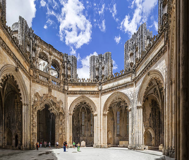 Tourists stroll around the interior of the Unfinished Chapels Batalha, Portugal - July 17, 2013: Tourists stroll around the interior of the Unfinished Chapels - Capelas Imperfeitas of the Batalha Monastery. UNESCO World Heritage Site. batalha abbey photos stock pictures, royalty-free photos & images