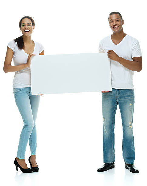 sonriente pareja sosteniendo cartel - black sign holding vertical fotografías e imágenes de stock