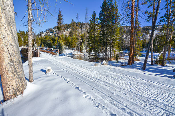 snowmobile trails lead over a small wood bridge