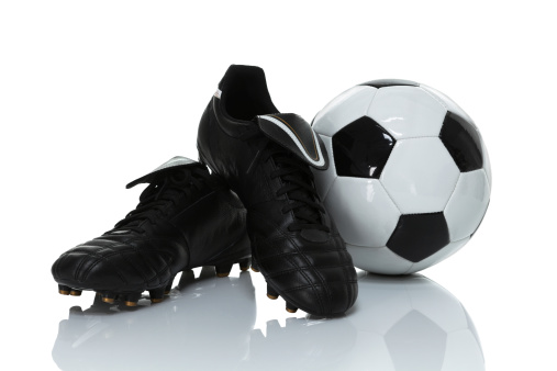 Close up shot of shoes and ball for soccer or european football