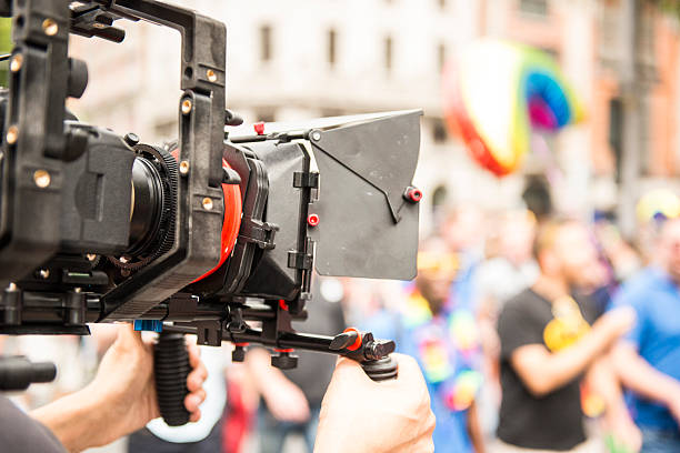 istock TV crew filming gay pride parade 481270748