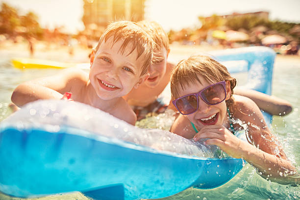 istock Kids having fun in sea on air bed 481270762