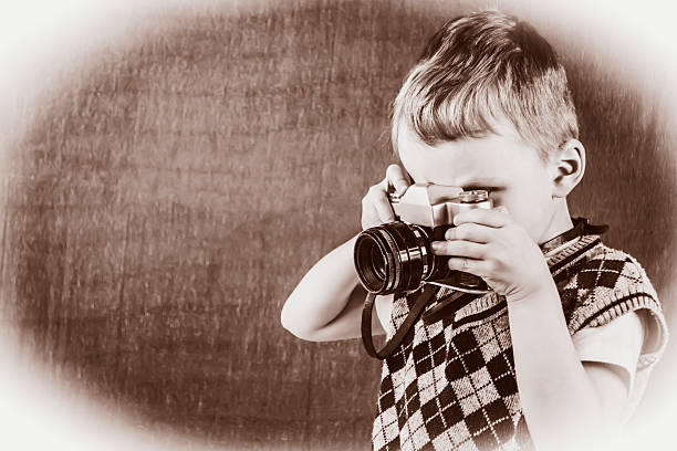 istock boy photographs the old camera 481273558