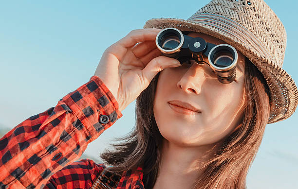 istock Traveler girl looking through binoculars 481273672