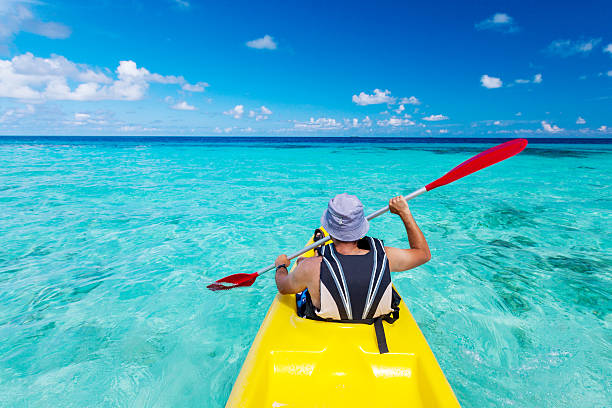 Man Kayaking in the Tropical Ocean