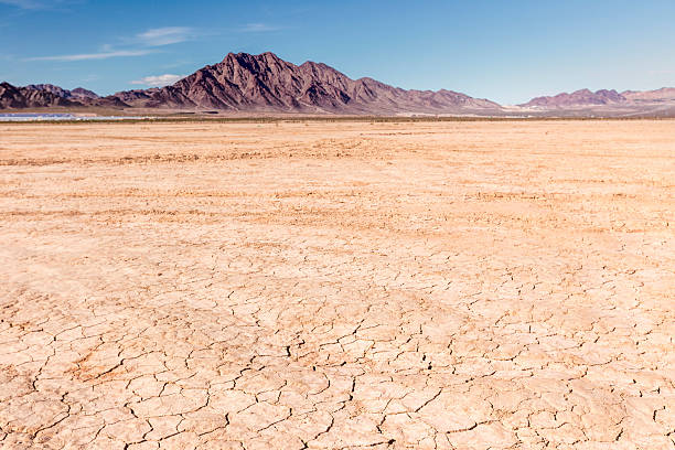 Dry lake bed in desert Cracked earth and deep blue skies, rocky mountains and alluvial fans in the panoramic image of the dry lake bed near Las Vegas, NV, California. Adobe RGB 1998 color profile. nevada landscape stock pictures, royalty-free photos & images