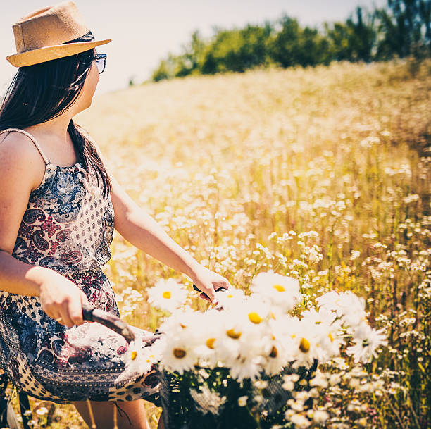 istock beautiful woman riding a bike 481274688