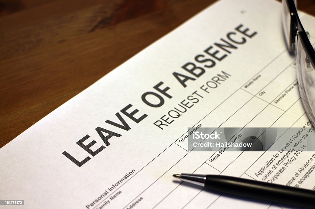 Leave of Absence Request Someone filling out Leave of Absence Request Form. Leaving Stock Photo