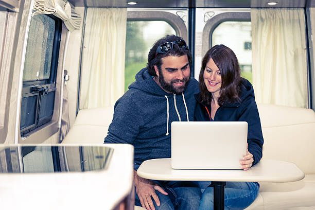 istock Adult Heterosexual Couple Using Laptop Inside Motorhome 481278522