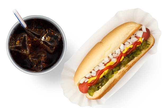 Ballpark Dog and Soda Ketchup, mustard, onion and relish on a hot dog with soft drink relish stock pictures, royalty-free photos & images