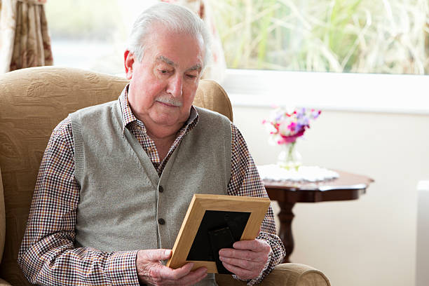 istock Senior Man Holding A Photo Frame 481281917