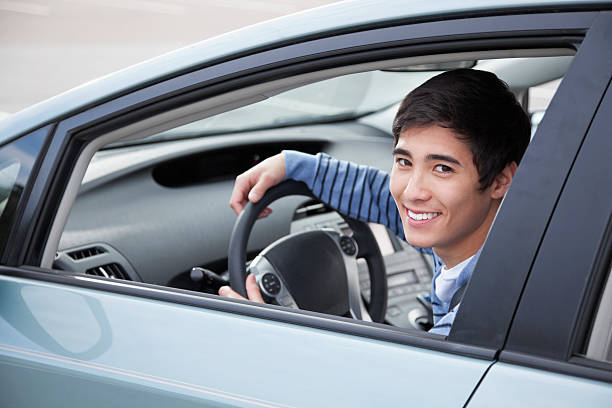 Teen driver Teenage boy (17 years) driving car. drivers seat stock pictures, royalty-free photos & images