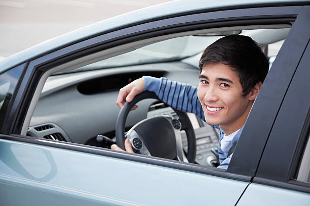 Teen driver Teenage boy (17 years) driving car. teenager boy driving stock pictures, royalty-free photos & images