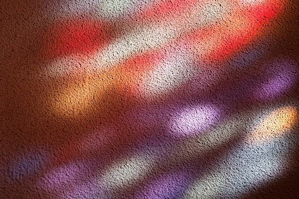 Stained glass window light patches on a church wall
