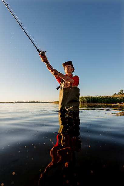 istock Fisherman Wearing Waders Casting His Line Out 481284918