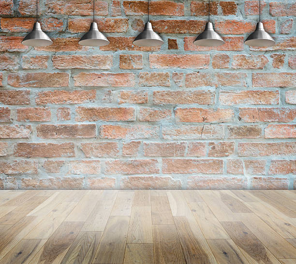 istock Lamp at brick wall background with ground wood 481287342