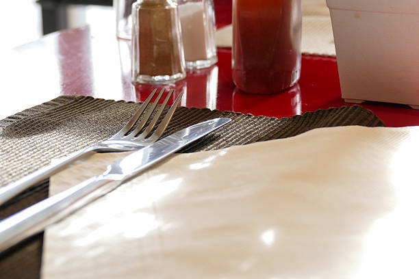 istock fork,knife, honey, pepper and salt on red table 481287478