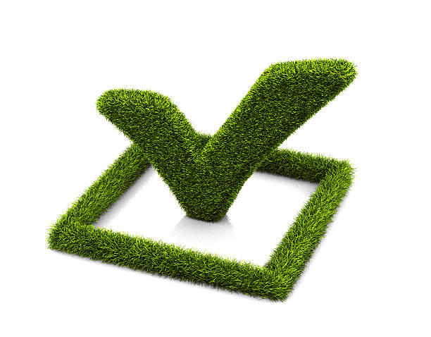 Green grassed check mark symbol in the square on white stock photo