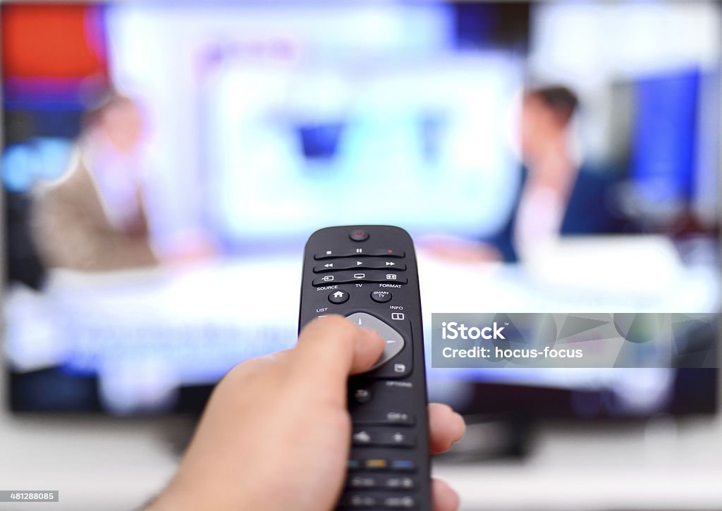 Watching news on TV Watching news on tv. Television Industry Stock Photo