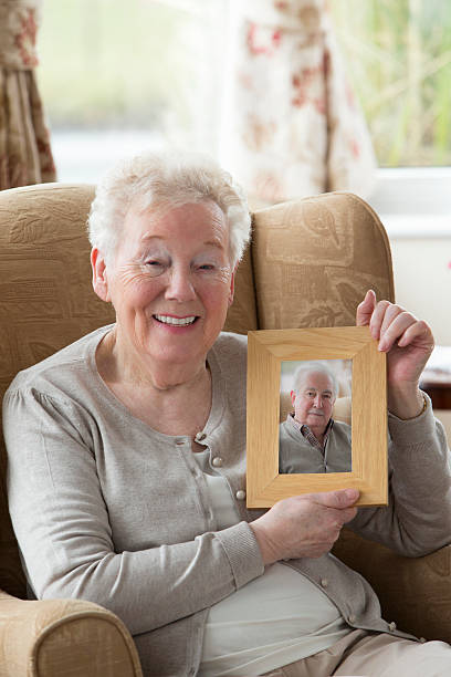 istock Senior Woman Holding A Photo Frame 481288211