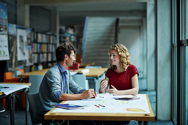 Two architects working on project Two architects working on project in studio architect office stock pictures, royalty-free photos & images