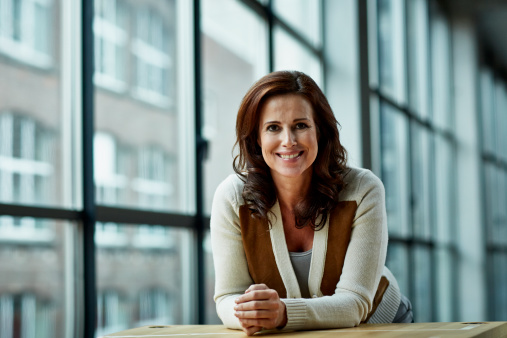 Portrait of female architect at high table in modern studio