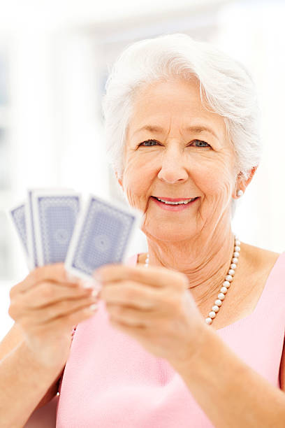 istock Happy Senior Woman Playing Cards 481293644
