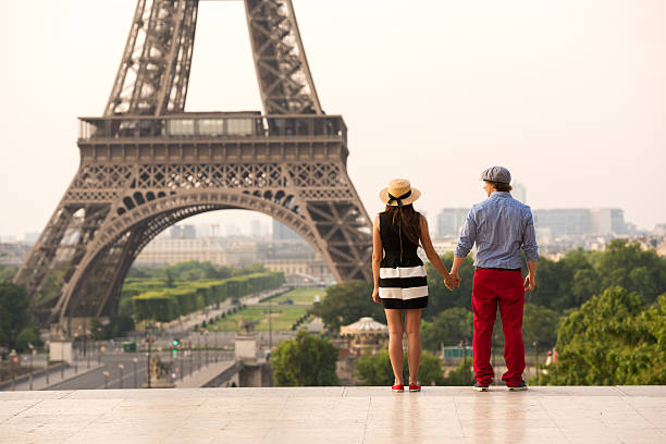 istock Couple holding hands at the Eiffel Tower in Paris 481296768