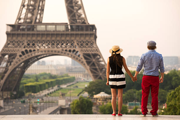 istock Couple holding hands at the Eiffel Tower in Paris 481296772
