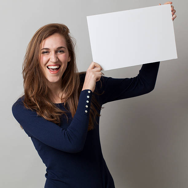 istock excited 20s woman making an ad, raising white insert 481296890
