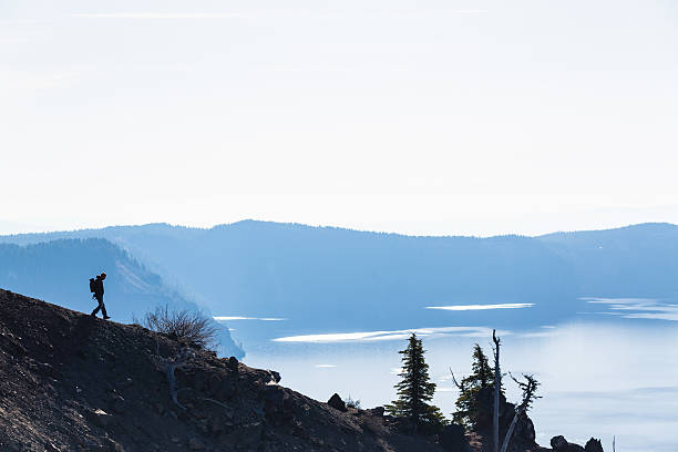 hiker explores the Crater Lake in Oregon.