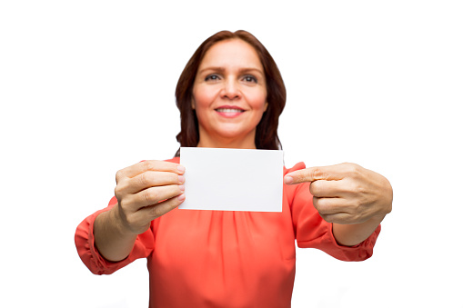 Close-up of a woman showing an empty business card and smiling isolated over white background