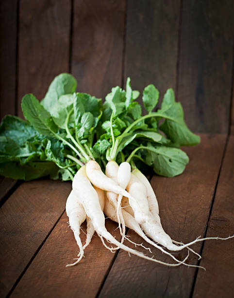 istock Fresh daikon radish on a wooden background 481304284