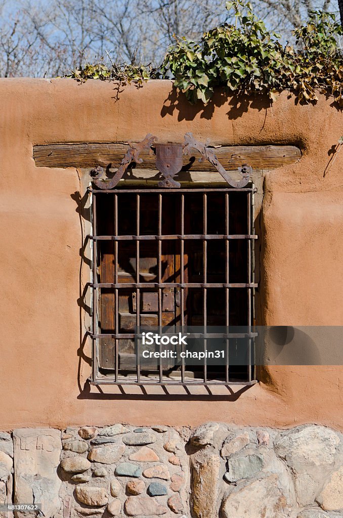 Wrought Iron Santa Fe Window A window with a wrought iron design exemplifies the typical Southwestern architecture of Santa Fe, New Mexico. 2015 Stock Photo