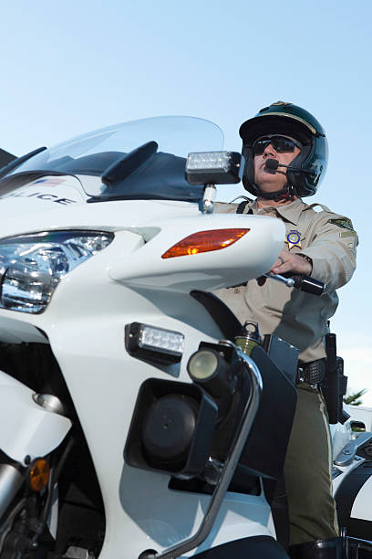 istock Traffic Cop Sitting On Bike Against Sky 481308095