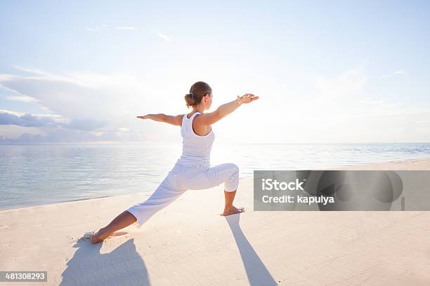 Caucasian Woman Practicing Yoga At Seashore Stock Photo - Download Image Now - Adult, Adults Only, Beach