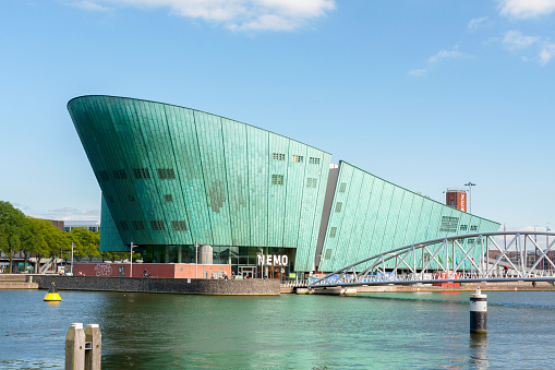 Amsterdam, the Netherlands - June 16, 2015: the  modern building of Science Center Nemo. The museum is located at the Oosterdok in Amsterdam-Centrum, situated between the Oosterdokseiland and Kattenburg. The museum was started in 1923, and the current headquarter, designed by Renzo Piano, is occupied since 1997.