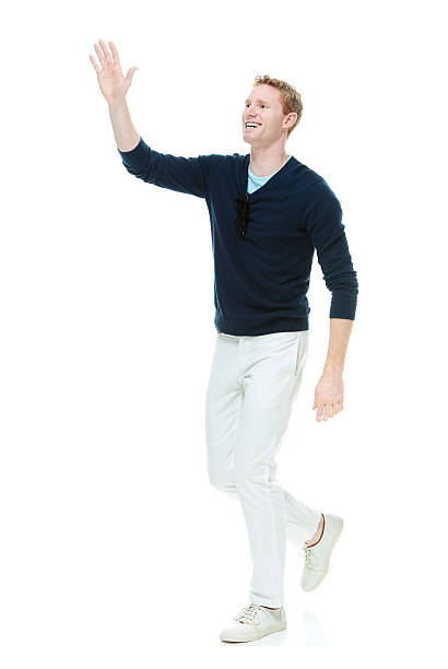 istock Smiling casual man waving hand and walking 481309406