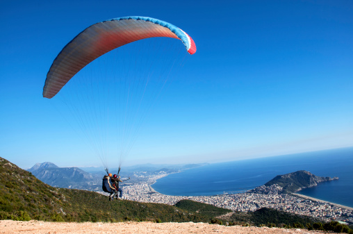 Two men soaring in a tandem paragliding flight