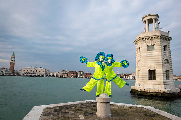 azul, amarillo y máscara de carnaval de venecia en san giorgio, italia, europa - couple performer people venice italy fotografías e imágenes de stock