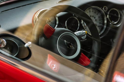 Toronto, Ontario, Canada- July 1, 2015. Cockpit interior of 2006 Mini Cooper S JCW small vehicle parked against great architecture at The Beach area of Toronto, near Lake Ontario. This MINI Cooper S is no ordinary JCW R53 model, it is one of 64 limited edition series for Canadian market only named Competition Edition. Vehicle in the photo is #40 . Mini has been around since 1959 and has been owned and issued by various car manufacturers. It is currently distributed as a BMW brand of vehicles. 